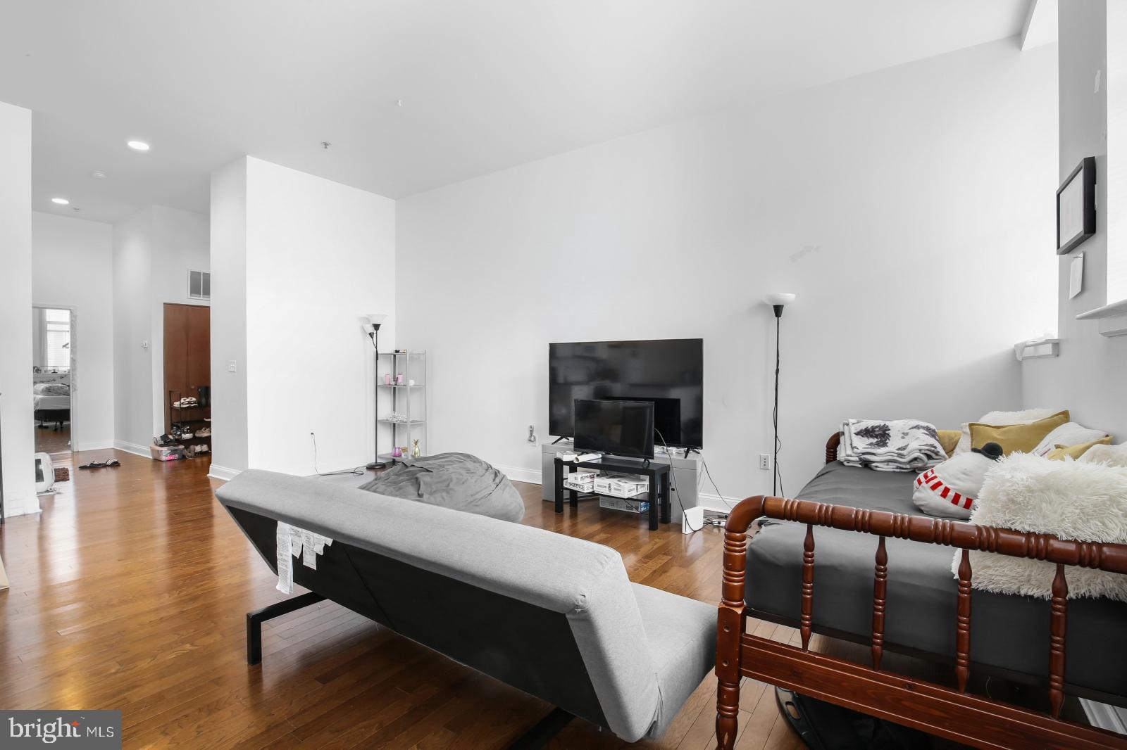 1001 Chestnut Street, Unit 903W Philadelphia, PA 19103 - Photo 6 of 21 a bedroom with furniture and a flat screen tv