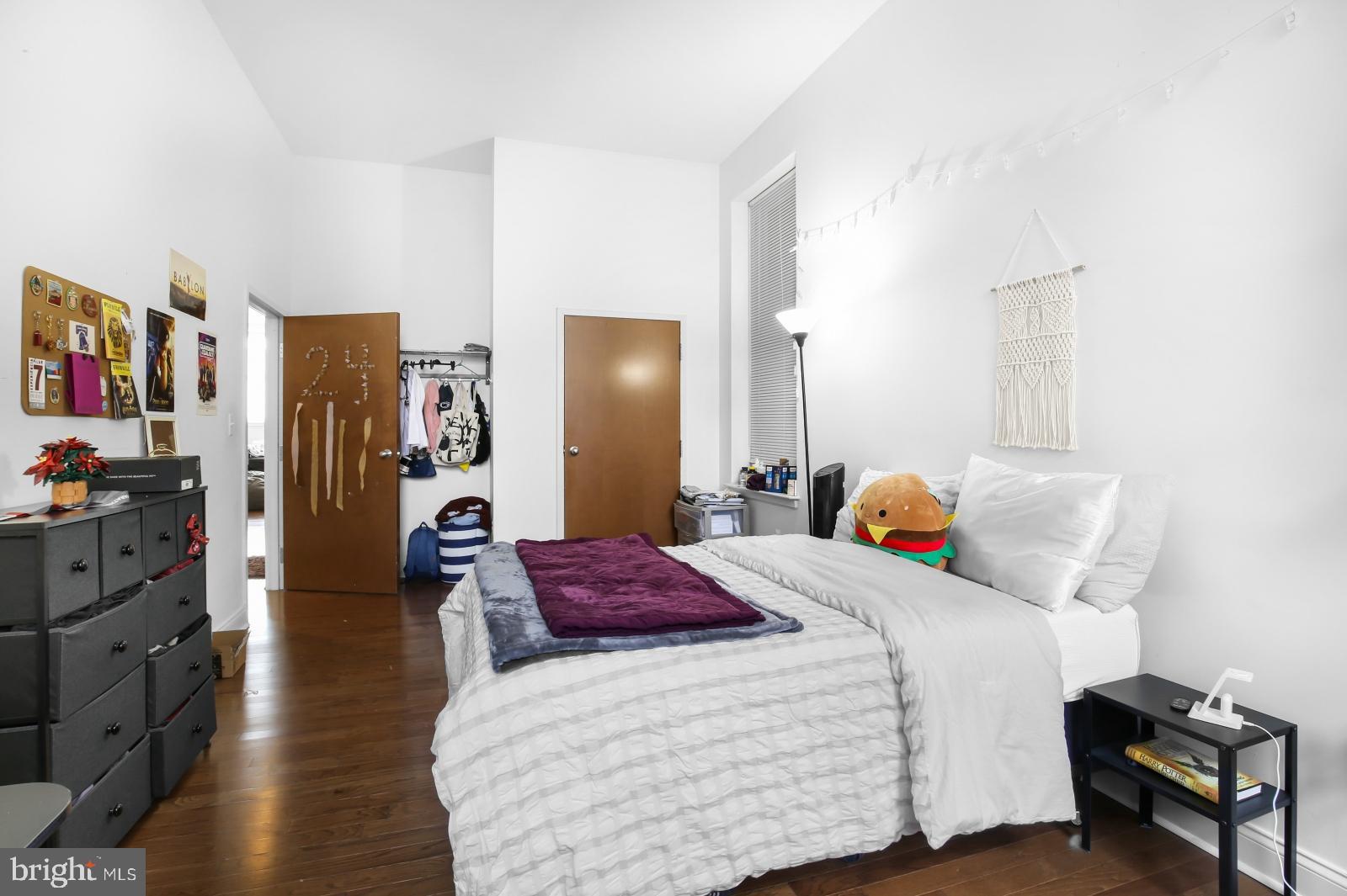 1001 Chestnut Street, Unit 903W Philadelphia, PA 19103 - Photo 9 of 21 a bedroom with a bed and wooden floor