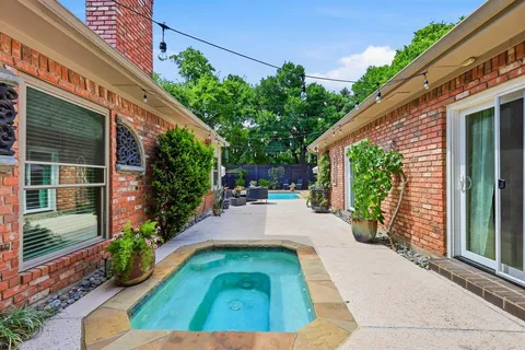 a view of a house with swimming pool and sitting area