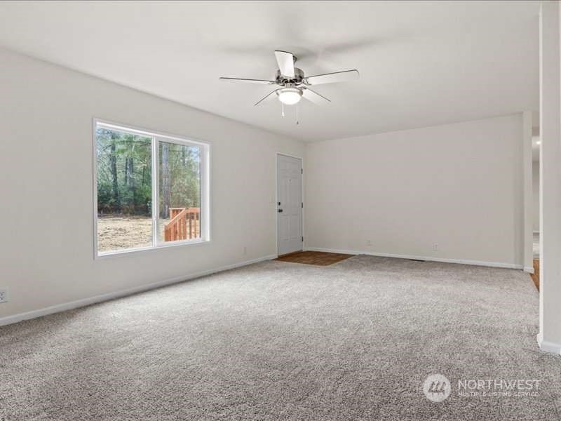 670 East Wilson Way Grapeview, WA 98546 - Photo 24 of 36 an empty room with windows and fan