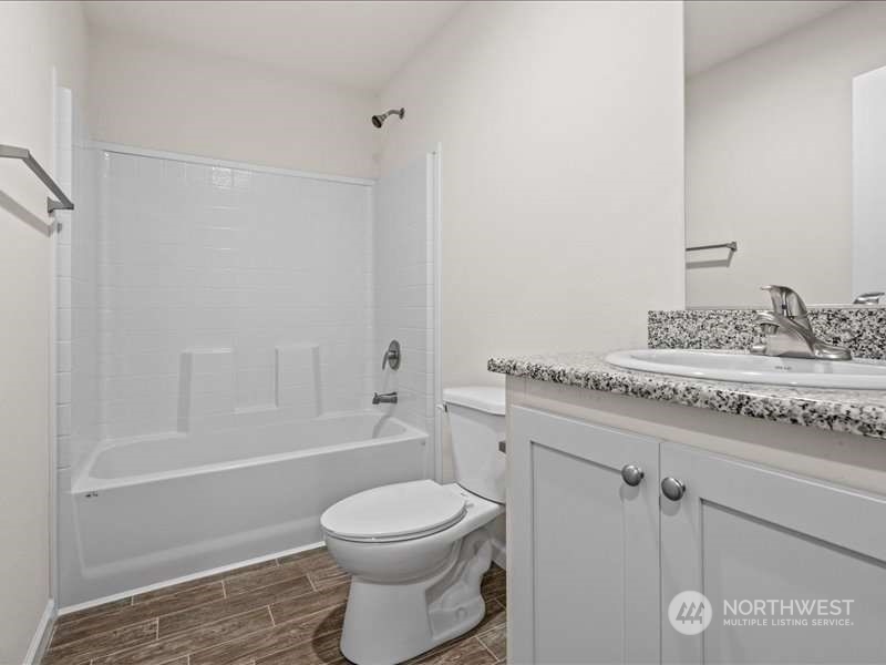 670 East Wilson Way Grapeview, WA 98546 - Photo 30 of 36 a bathroom with a granite countertop sink a toilet and shower