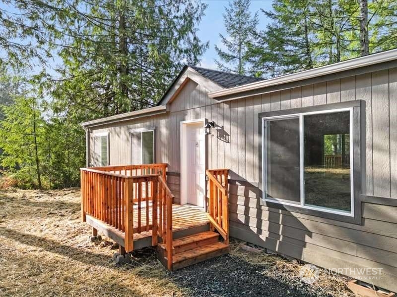 670 East Wilson Way Grapeview, WA 98546 - Photo 3 of 36 a view of a house with backyard and deck