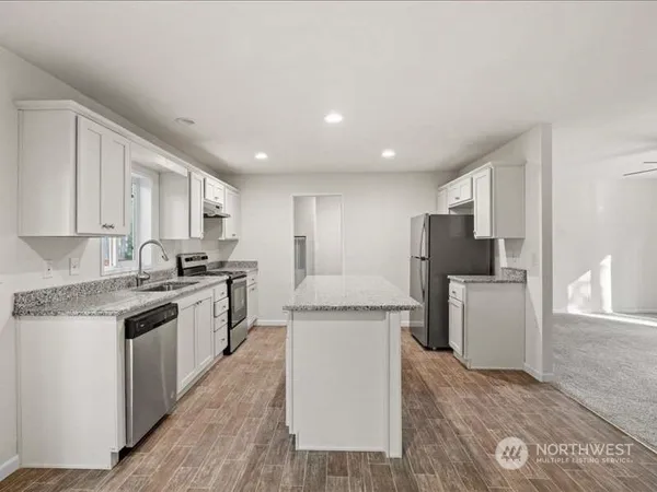 a kitchen with a sink stove and refrigerator