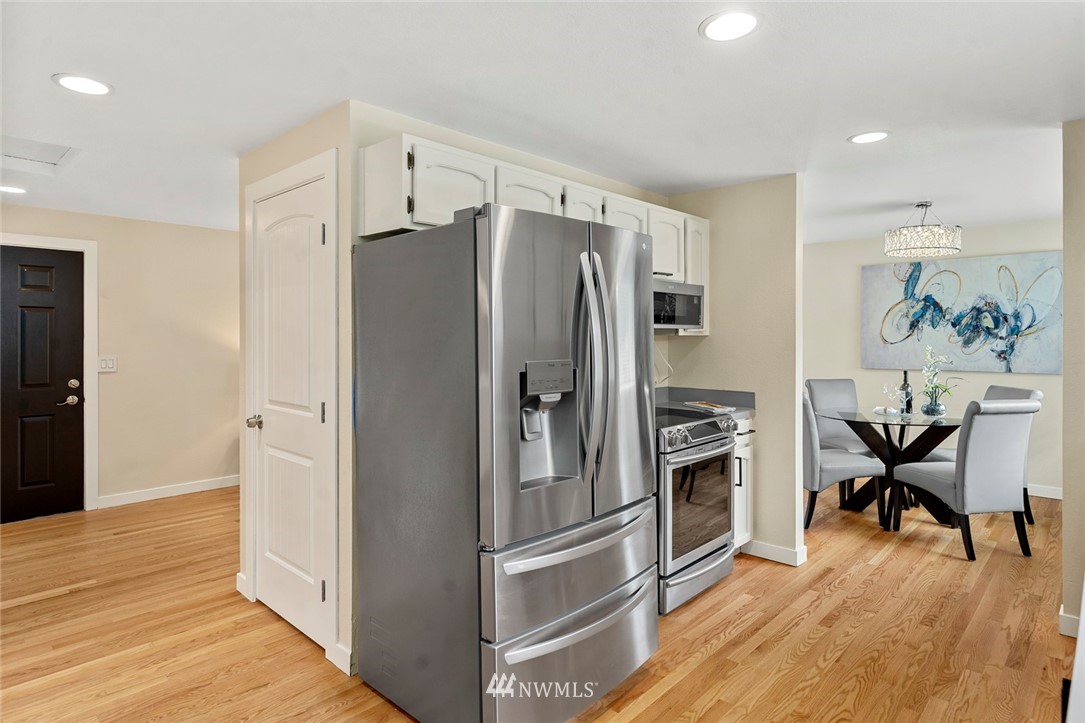 1624 174th Place Southeast Bothell, WA 98012 - Photo 13 of 36 a kitchen with stainless steel appliances a refrigerator and a stove top oven