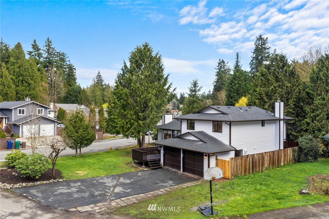 1624 174th Place Southeast Bothell, WA 98012 - Photo 29 of 36 a front view of a house with a yard and trees
