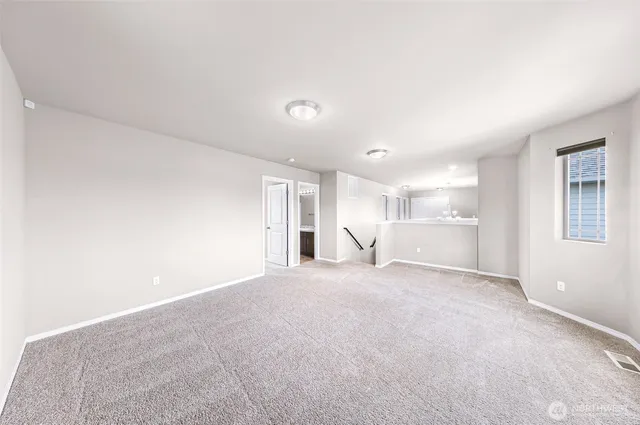 a bathroom with a granite countertop sink a toilet a mirror a bathtub and shower