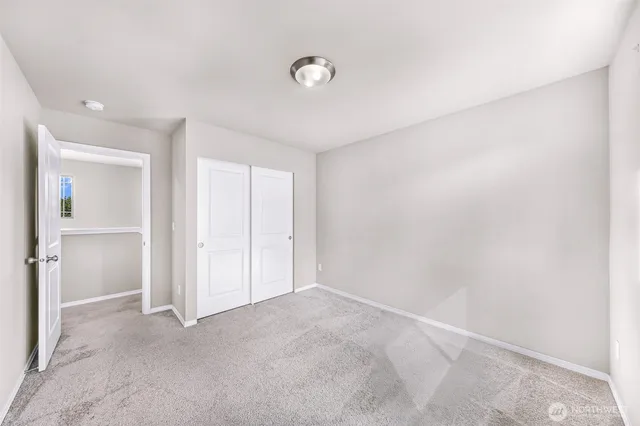 a utility room with dryer washer and a view of kitchen