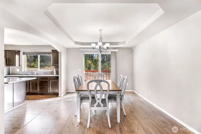 a view of a dining room with furniture wooden floor and chandelier