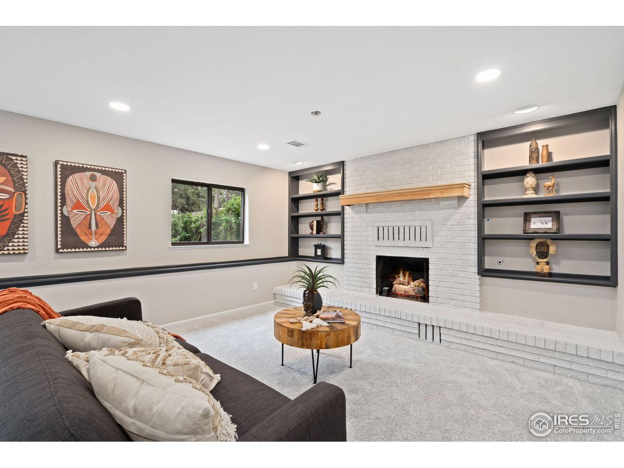 430 Del Clair Road Fort Collins, CO 80525 - Photo 11 of 20 Family room with built in shelves and gas log fireplace