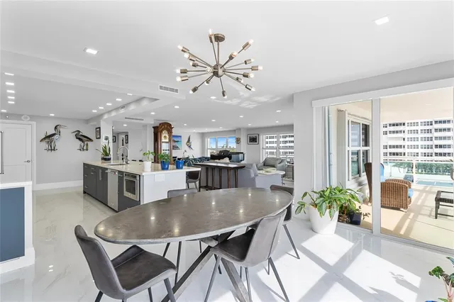 a bedroom with a bed a large window with table and chairs