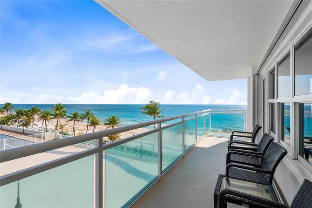 a dining room with furniture window and wooden floor