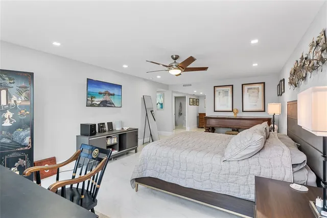 a large kitchen with stainless steel appliances a large counter top a stove and a chandelier