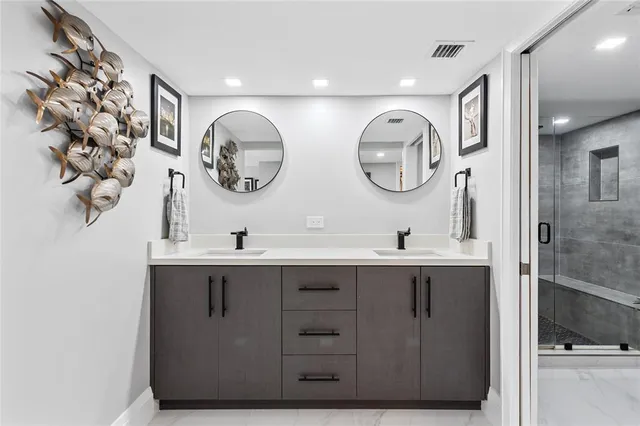 a large white kitchen with lots of counter space and a refrigerator
