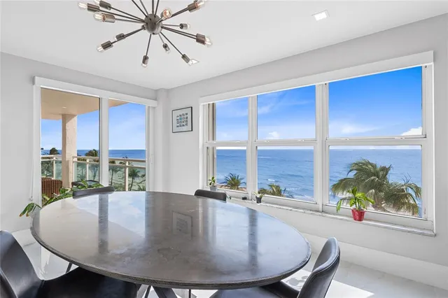 a living room with furniture and view of kitchen