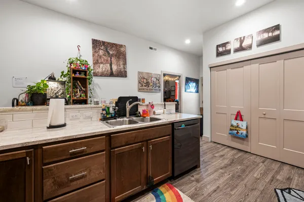 a kitchen with sink cabinets and wooden floor