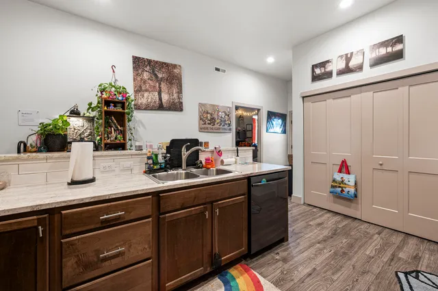 a kitchen with sink cabinets and wooden floor