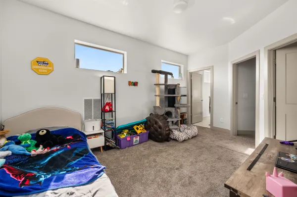 a bedroom with a bed and a window