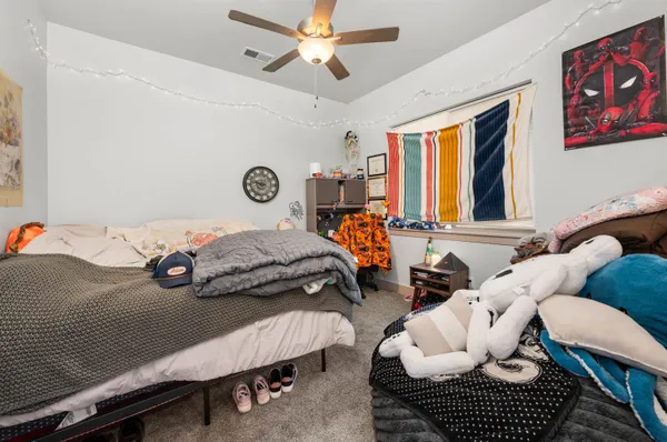 a bedroom with furniture and a chandelier
