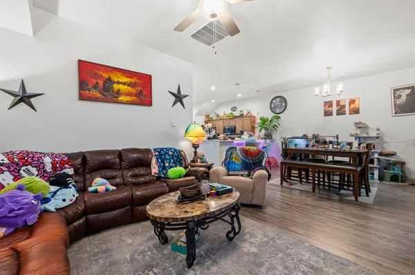 a living room with furniture and wooden floor