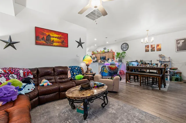 a living room with furniture and wooden floor