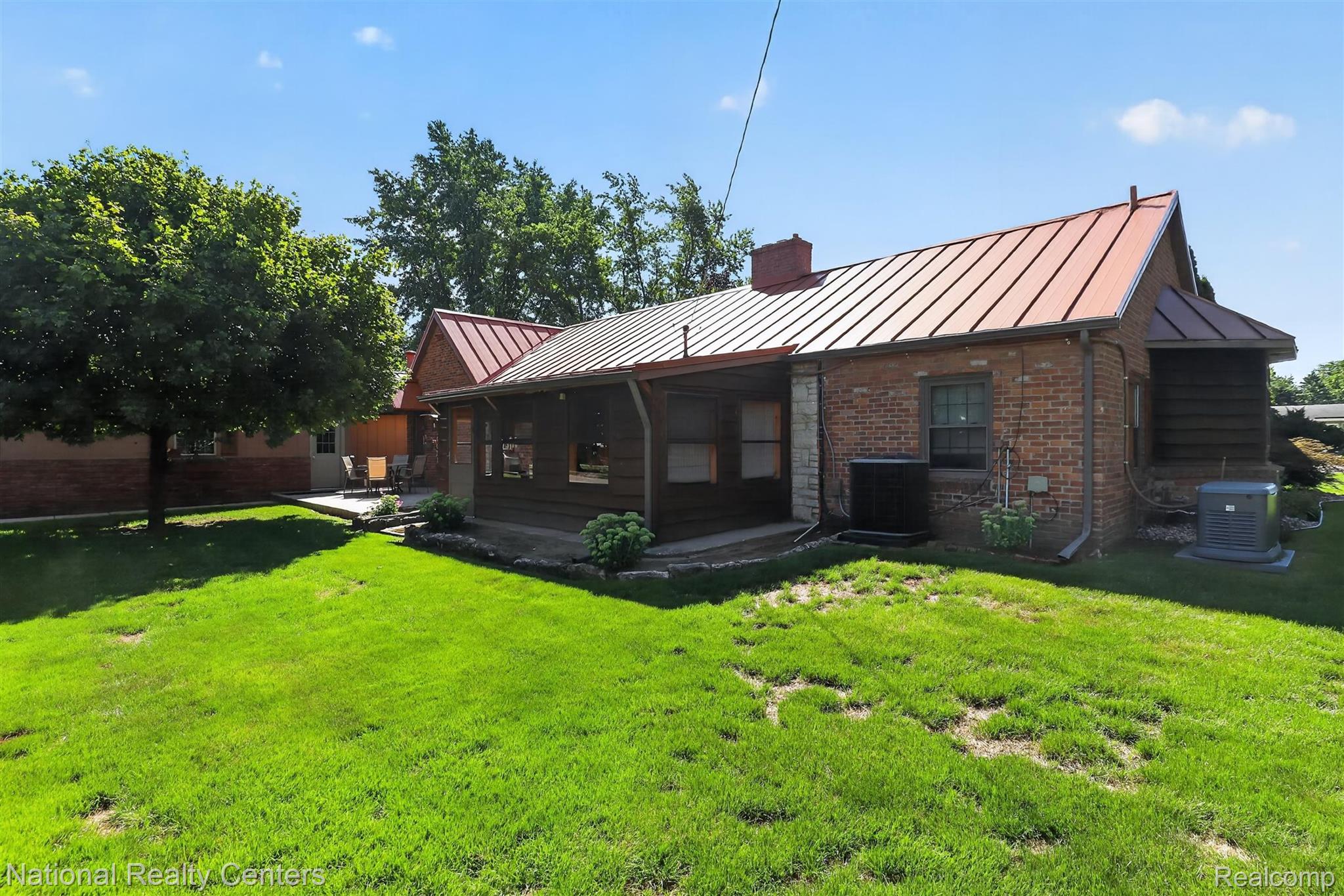 127 West Albain Road Petersburg, MI 49270 - Photo 50 of 61 Expansive backyard with a manicured lawn, brick exterior, and a screened-in porch