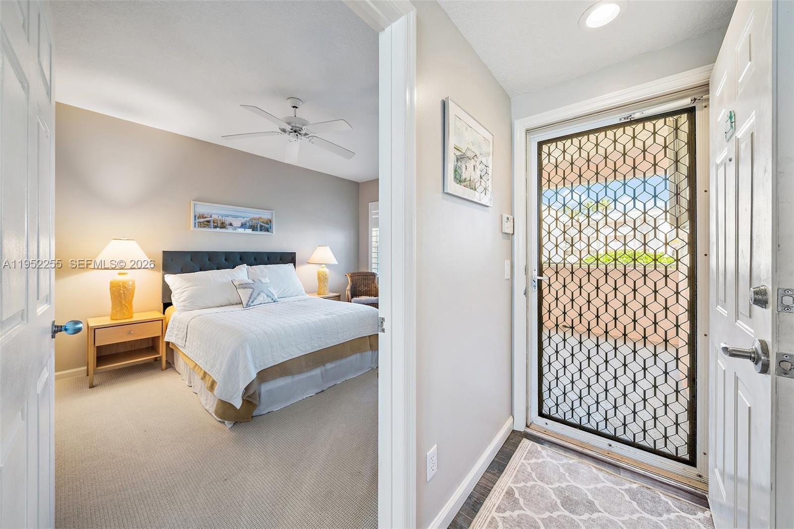 5800 Northeast Island Cove Way, Unit 2207 Stuart, FL 34996 - Photo 17 of 27 a bedroom with a bed and a window