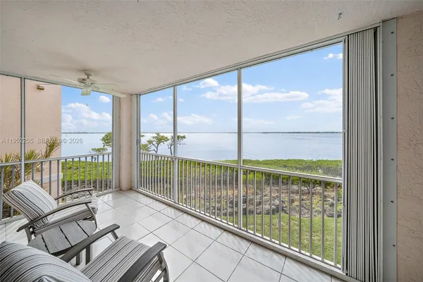 a view of a porch with furniture and floor to ceiling window