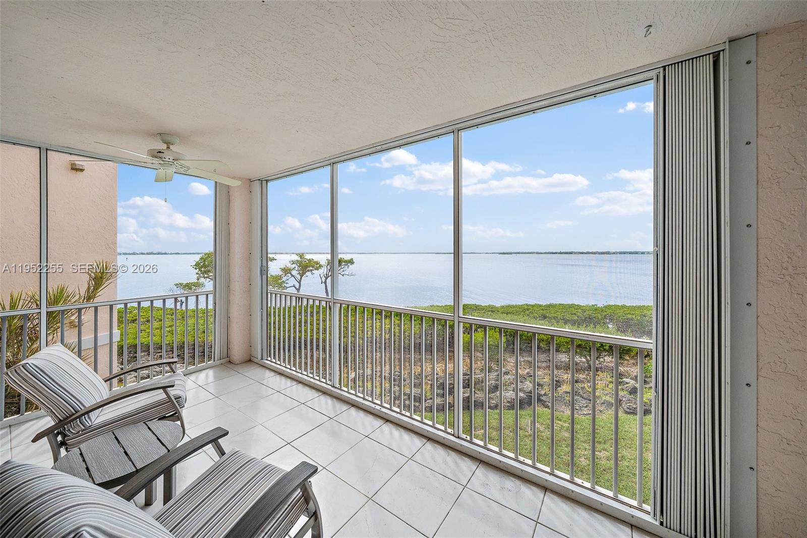 5800 Northeast Island Cove Way, Unit 2207 Stuart, FL 34996 - Photo 2 of 27 a view of a porch with furniture and floor to ceiling window