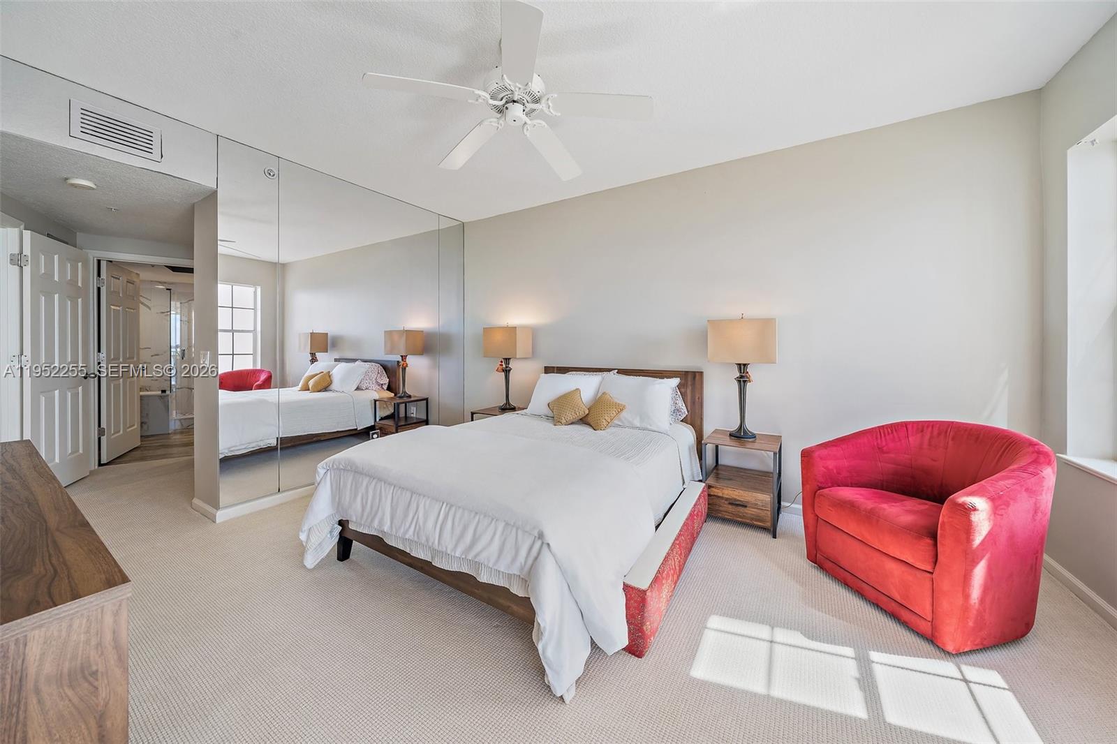 5800 Northeast Island Cove Way, Unit 2207 Stuart, FL 34996 - Photo 10 of 27 a spacious bedroom with two bed and a couch