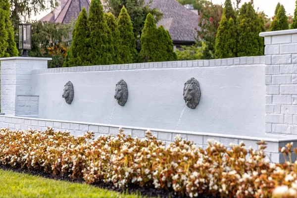 a bathroom with a granite countertop sink a mirror and a potted plant