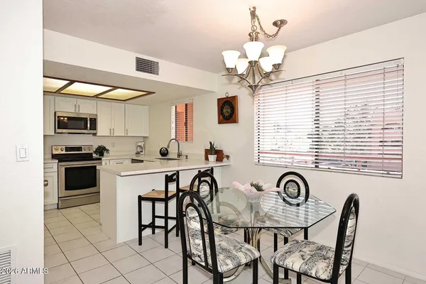 a kitchen with a table chairs stove and microwave