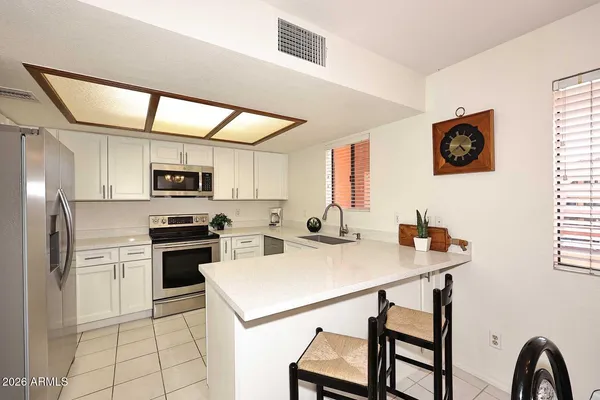 a kitchen with a sink stove and microwave