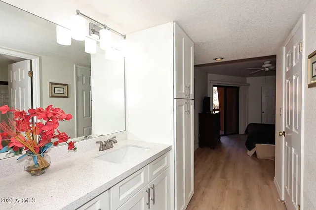 a view of a sign board with yard and ocean view