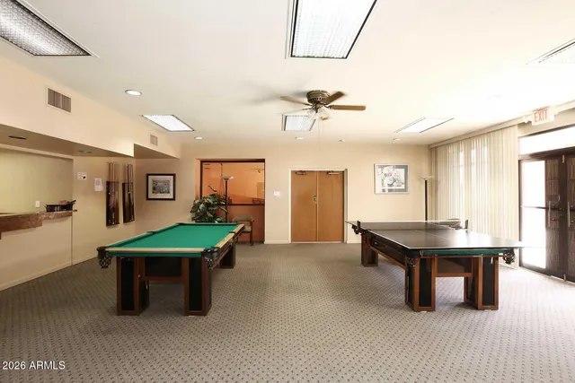 a front view of multi story residential apartment building with a yard