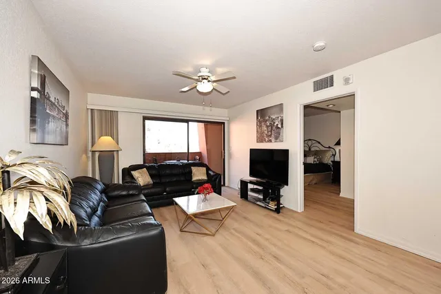 a living room with furniture a table and a flat screen tv