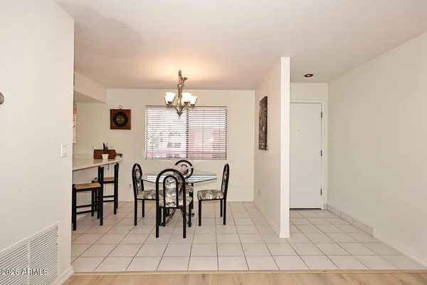 a kitchen with stainless steel appliances kitchen island granite countertop a refrigerator a stove a sink dishwasher and white cabinets with wooden floor