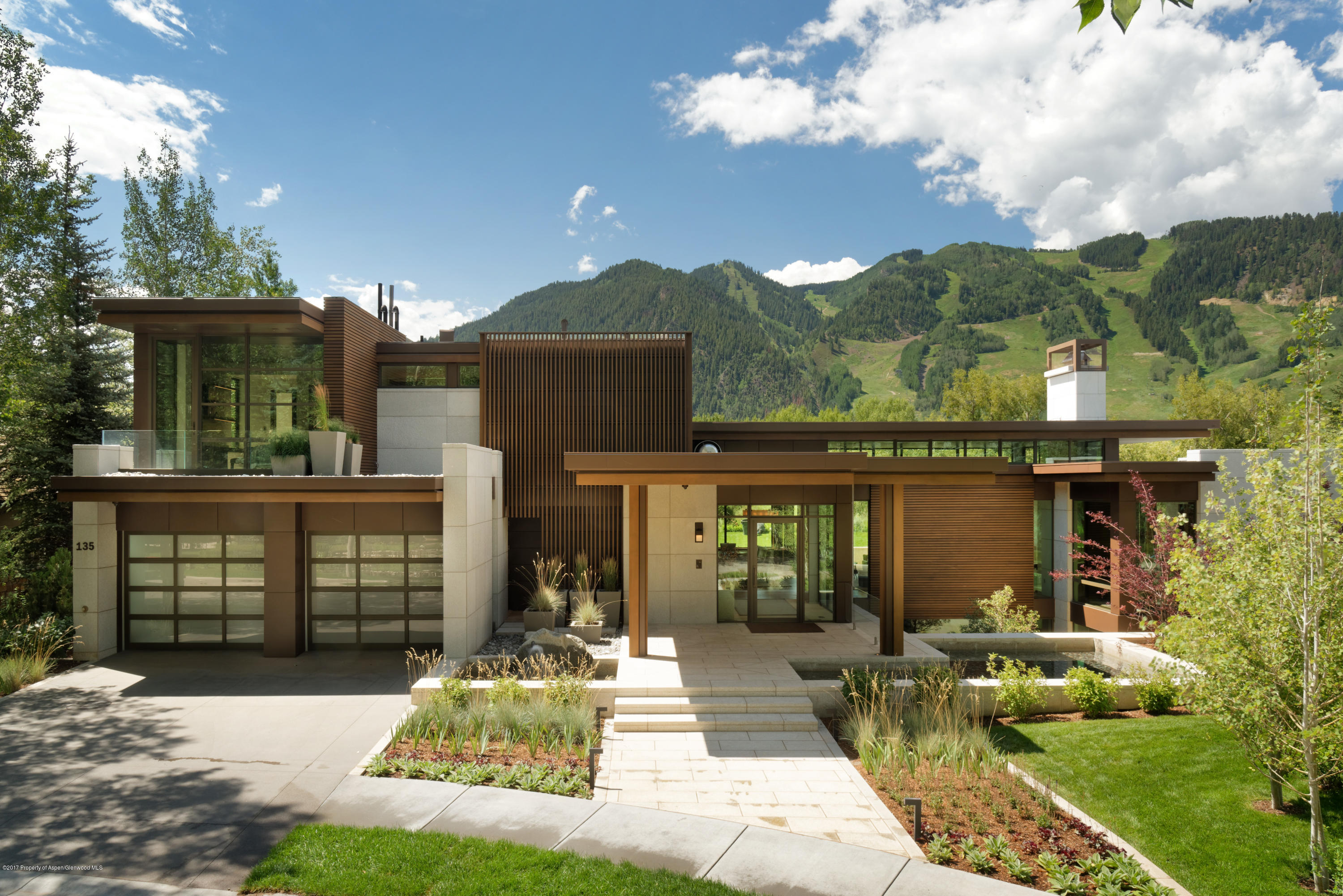 a view of a house with sitting area and garden