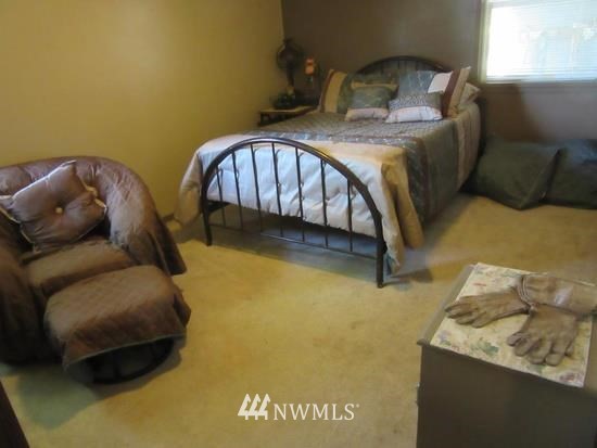 141 Rogers Road Prescott, WA 99348 - Photo 17 of 40 a bedroom with a bed and a couch