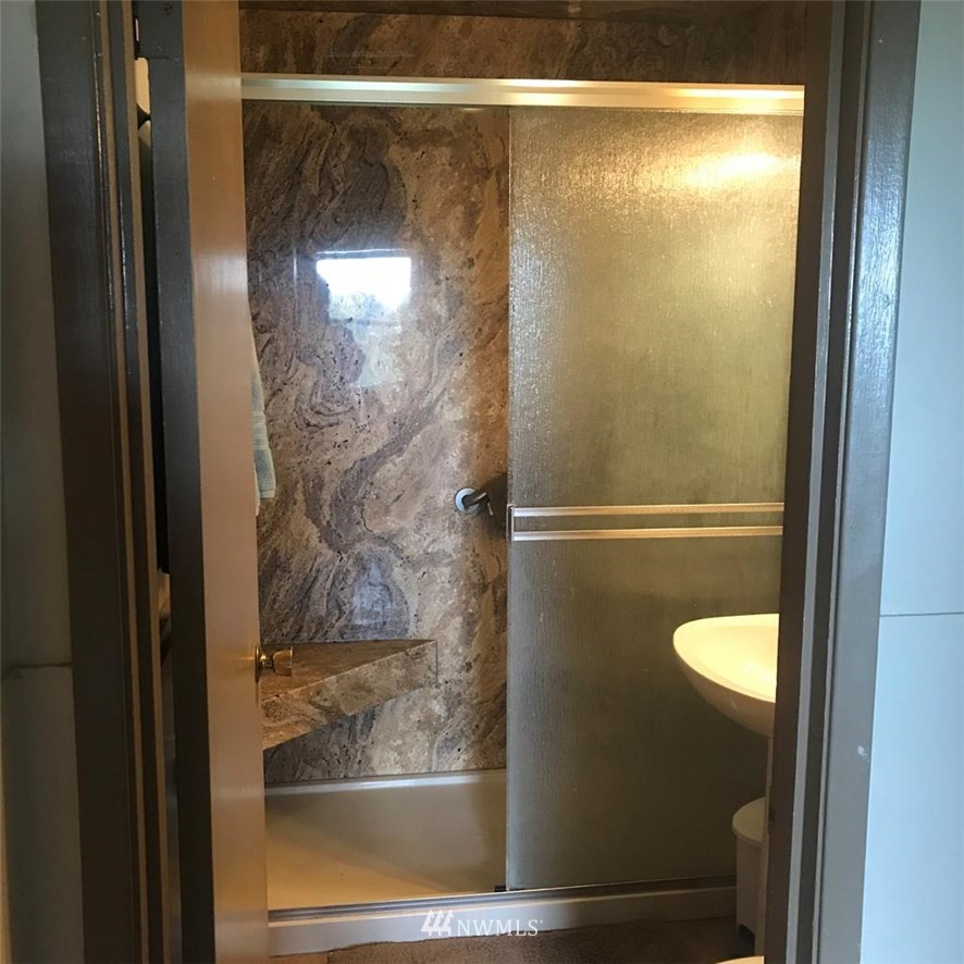 141 Rogers Road Prescott, WA 99348 - Photo 18 of 40 a bathroom with a glass shower door