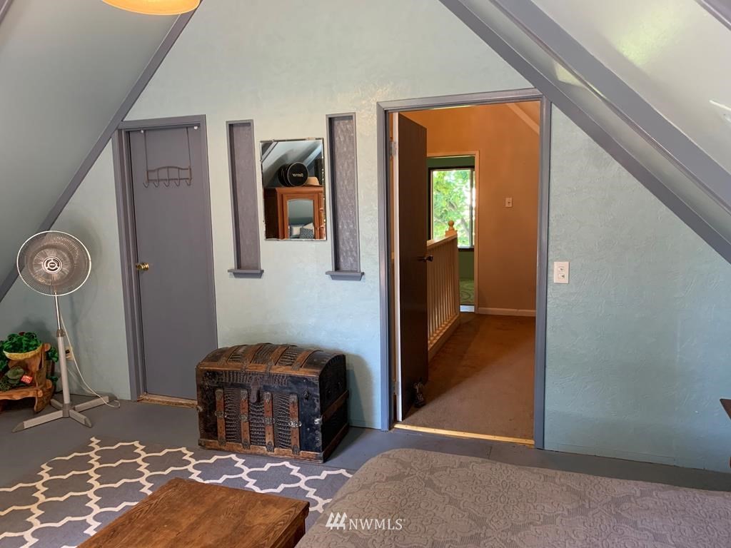 141 Rogers Road Prescott, WA 99348 - Photo 21 of 40 a bedroom with a bed and a chandelier