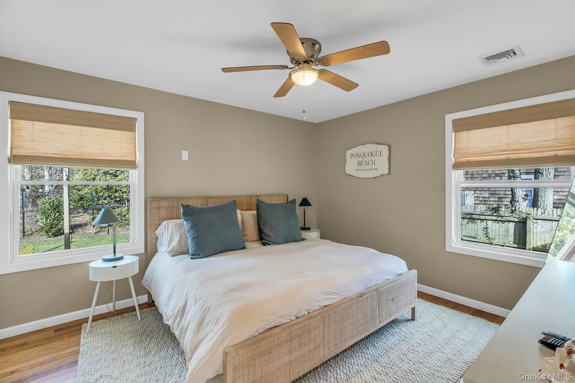 79 School Street Hampton Bays, NY 11946 - Photo 11 of 49 a bedroom with a large bed and a window