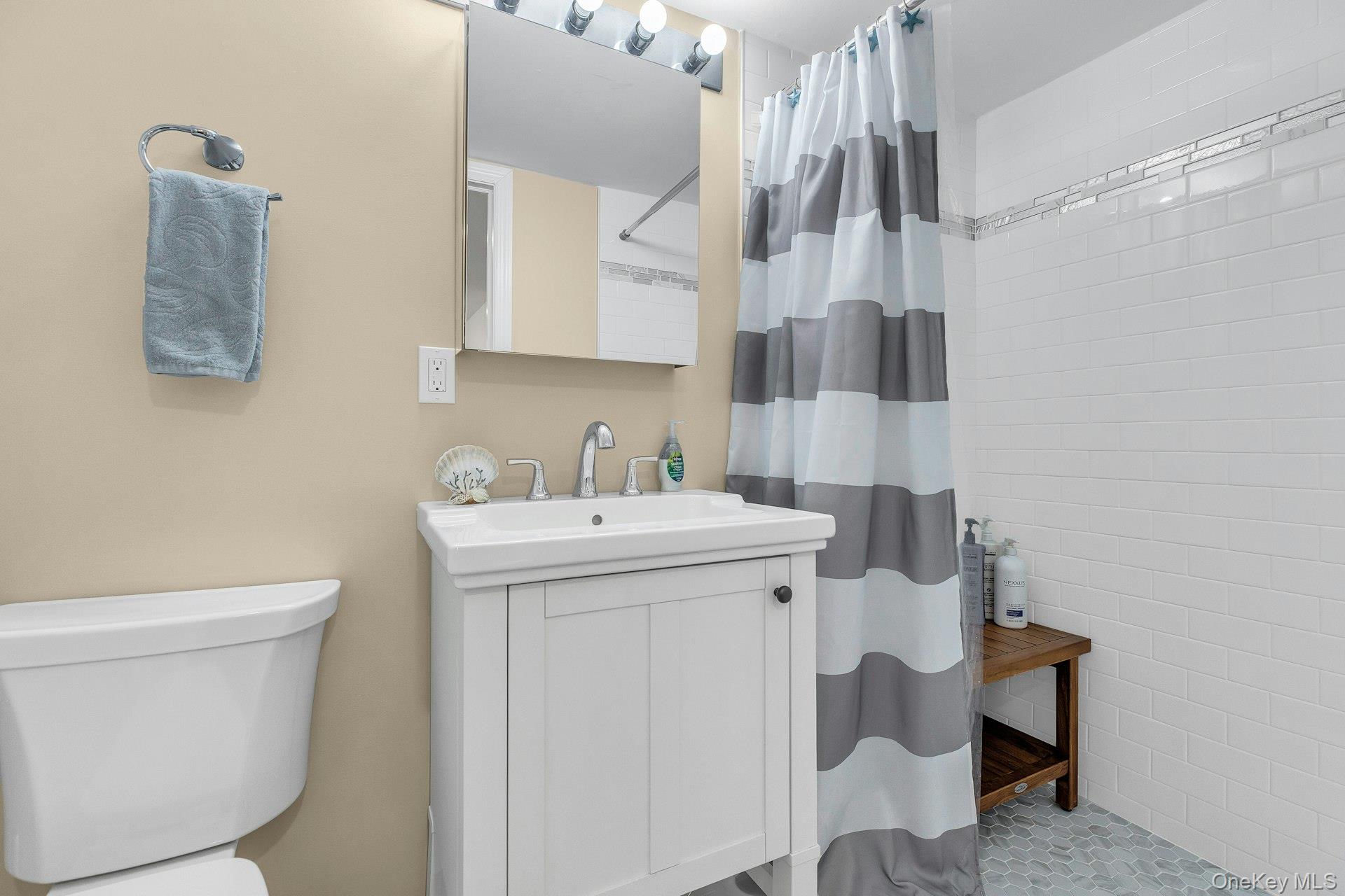 79 School Street Hampton Bays, NY 11946 - Photo 19 of 49 a bathroom with a sink toilet and shower