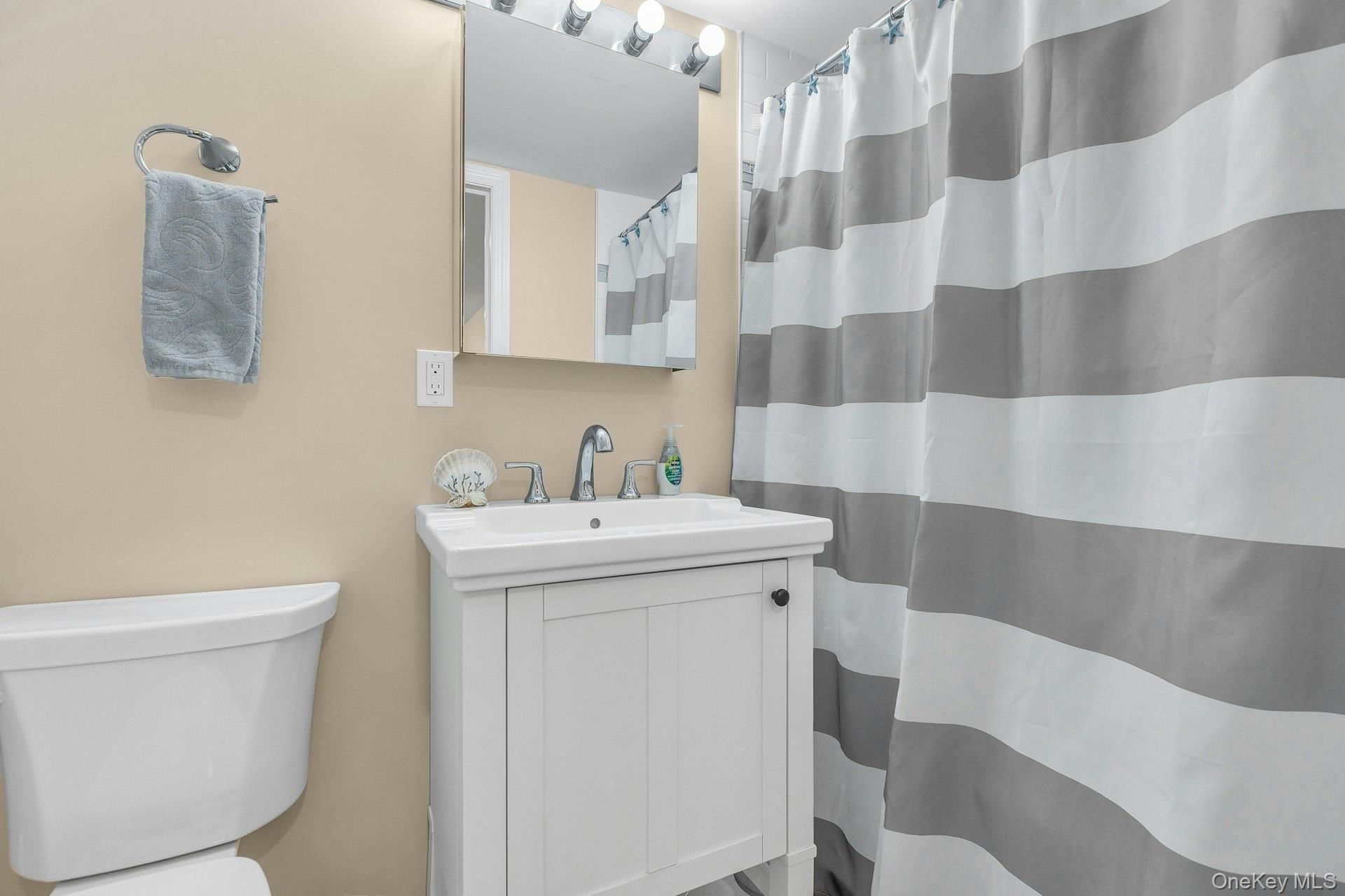 79 School Street Hampton Bays, NY 11946 - Photo 20 of 49 a view of bathroom with a sink and mirror