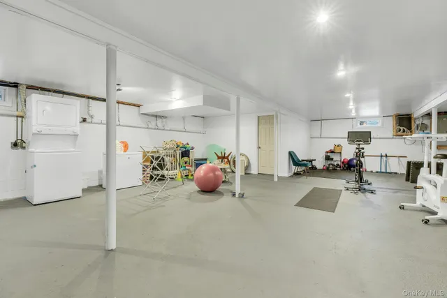 a view of a room with gym equipment and a large window