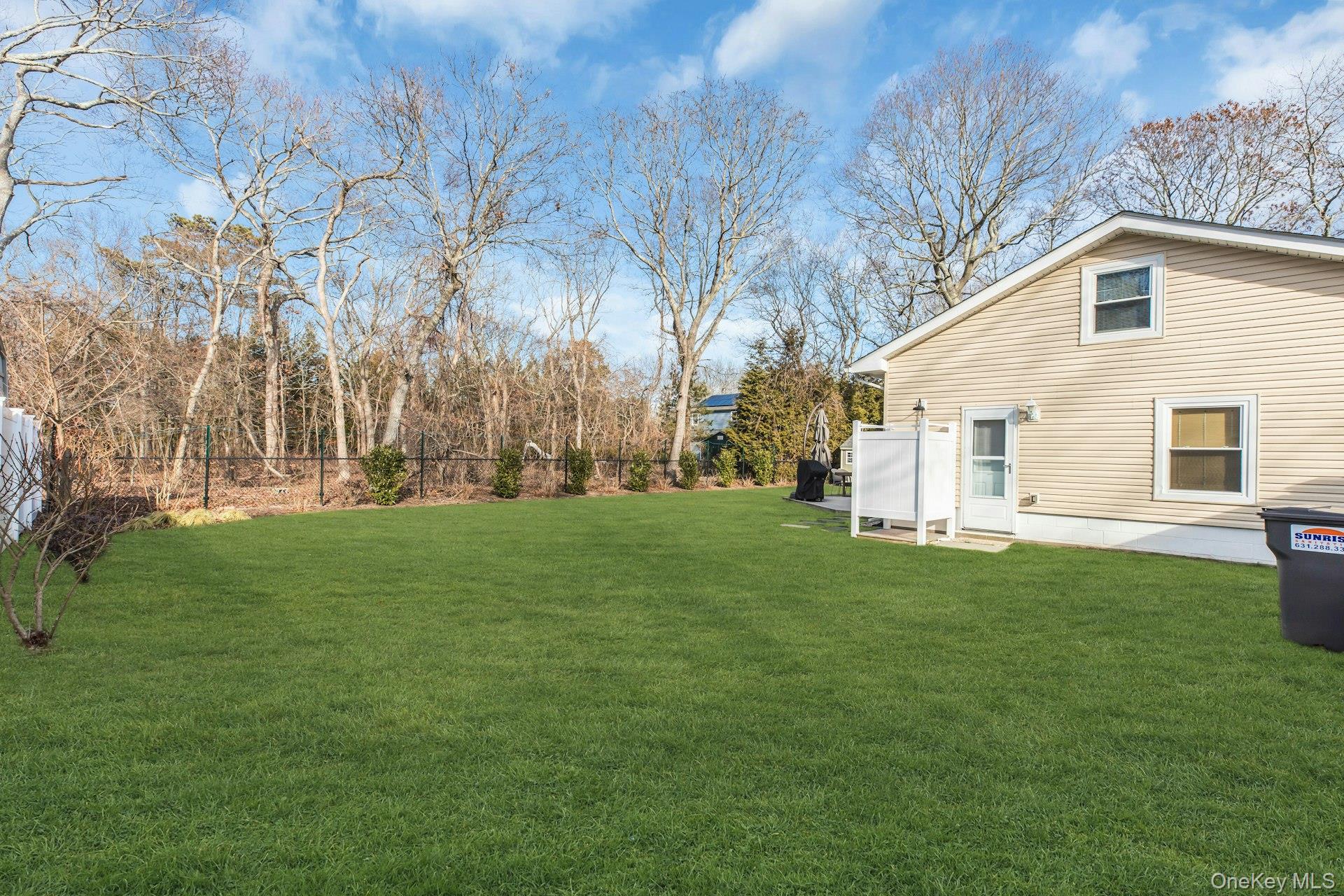 79 School Street Hampton Bays, NY 11946 - Photo 24 of 49 a view of a backyard with large trees