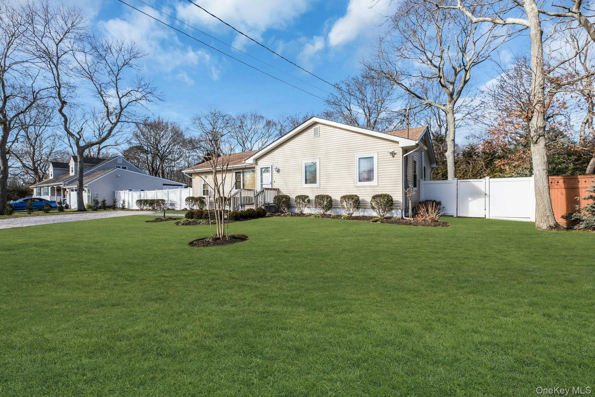 79 School Street Hampton Bays, NY 11946 - Photo 31 of 49 a front view of a house with a garden