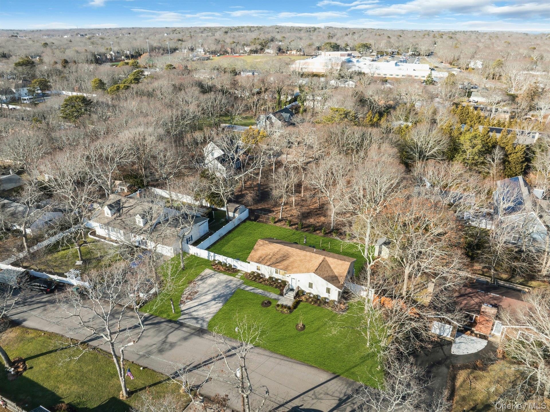 79 School Street Hampton Bays, NY 11946 - Photo 32 of 49 an aerial view of a house with a yard