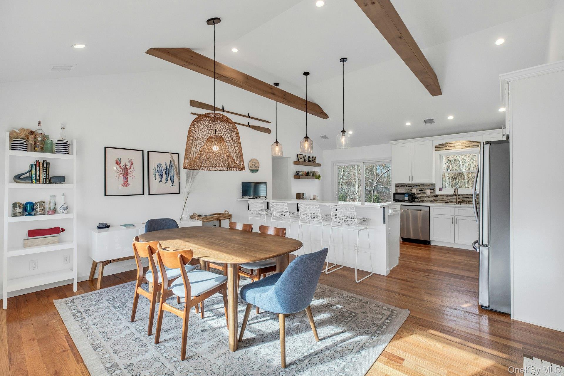 79 School Street Hampton Bays, NY 11946 - Photo 4 of 49 a kitchen with stainless steel appliances granite countertop a dining table chairs and view of living room