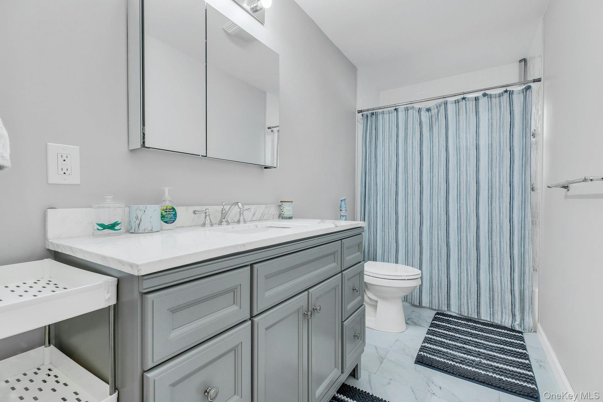 79 School Street Hampton Bays, NY 11946 - Photo 10 of 49 a bathroom with a sink toilet and vanity
