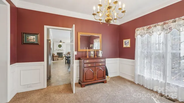 a spacious bedroom with a bed and a chandelier